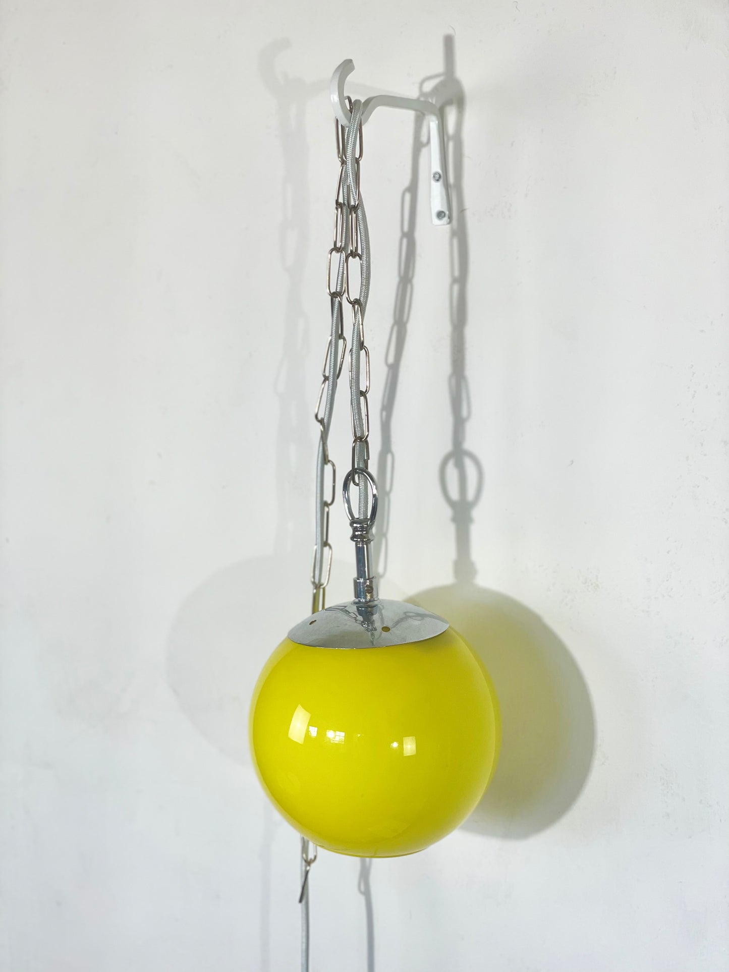Yellow globe chained pendant lamp