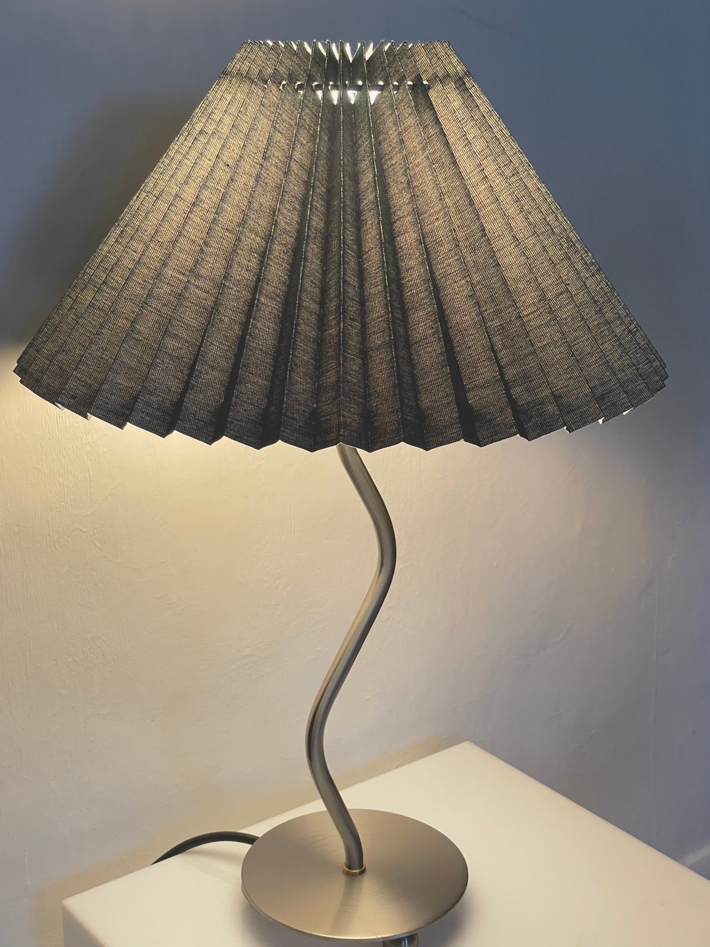 Wiggle lamp with green pleated shade