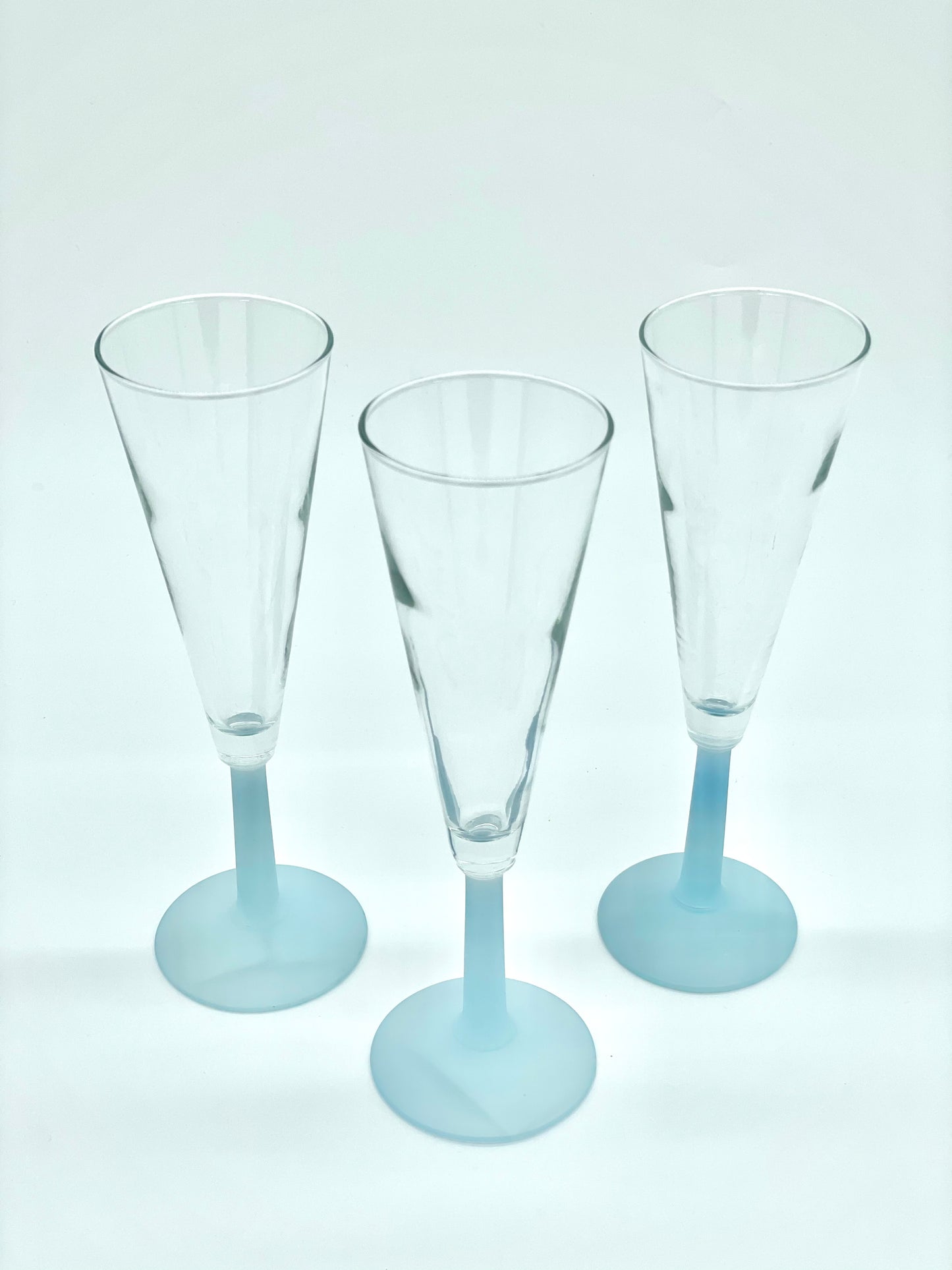 Set of three baby blue stemmed fluted glasses