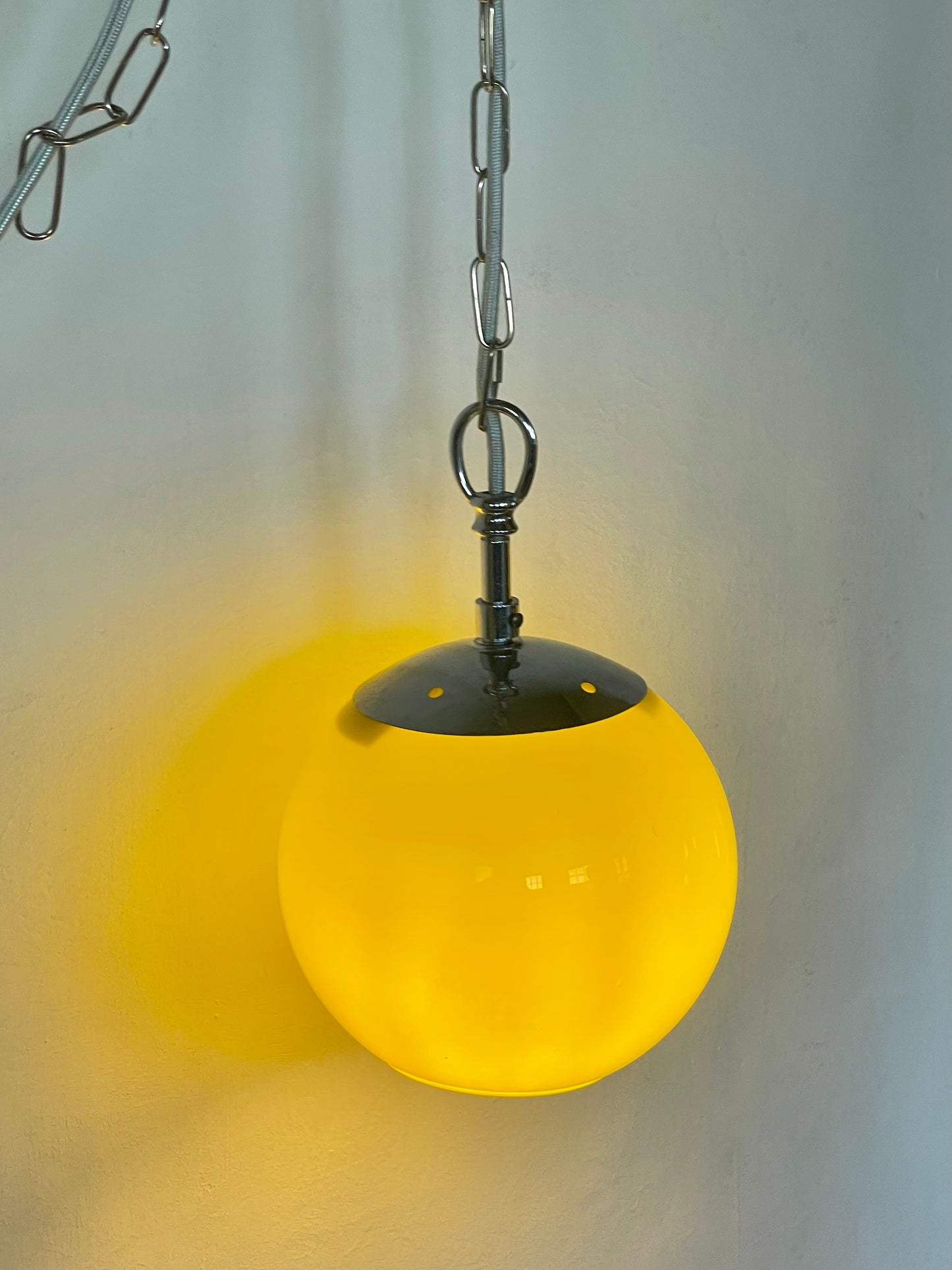 Yellow globe chained pendant lamp