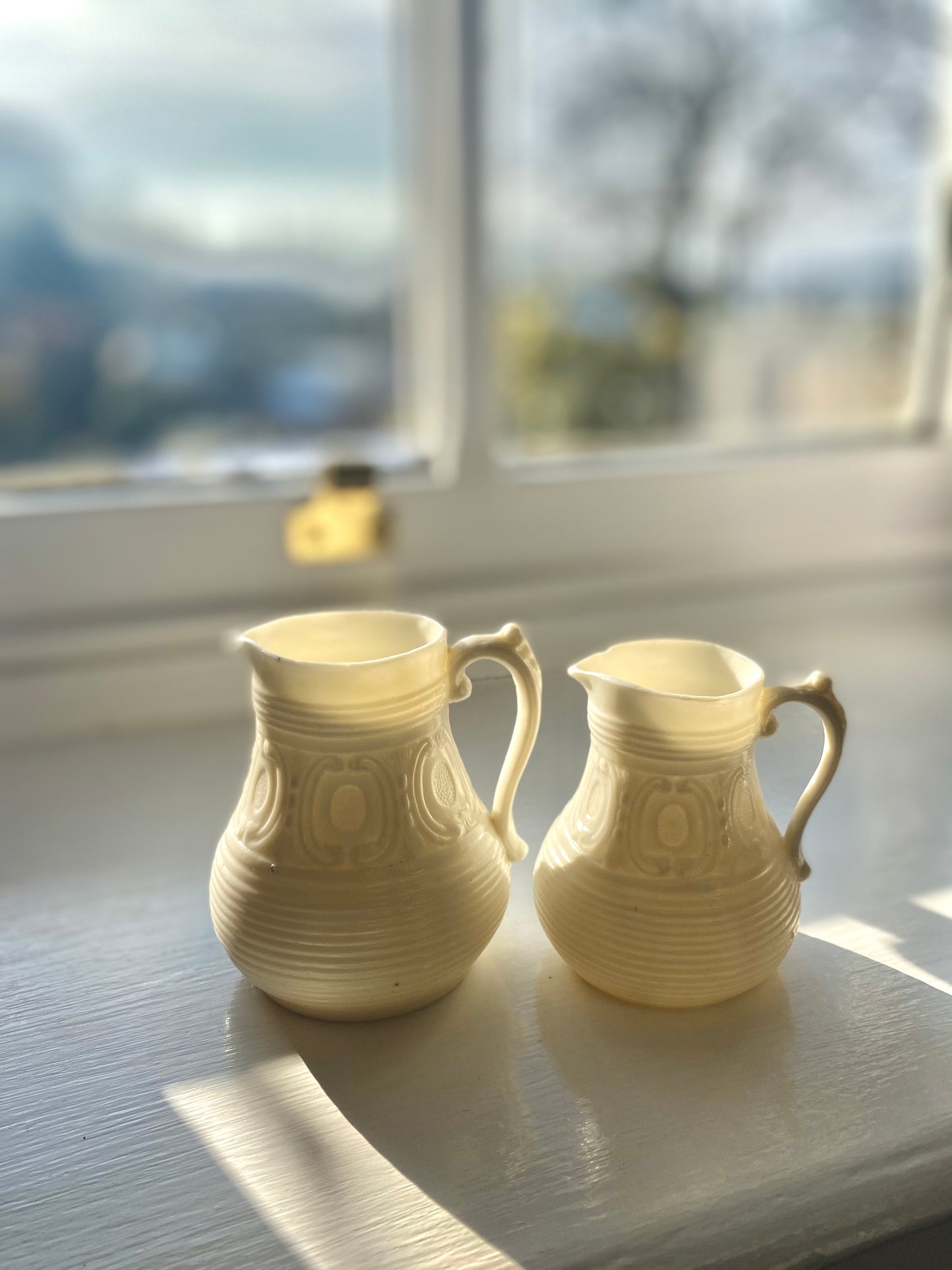 Pair of Ivory coloured Parian ware jugs