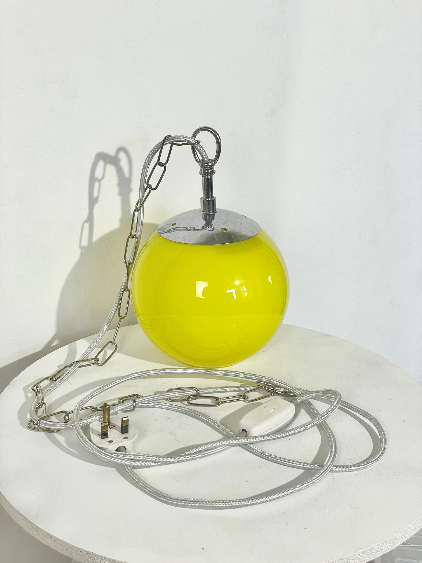 Yellow globe chained pendant lamp