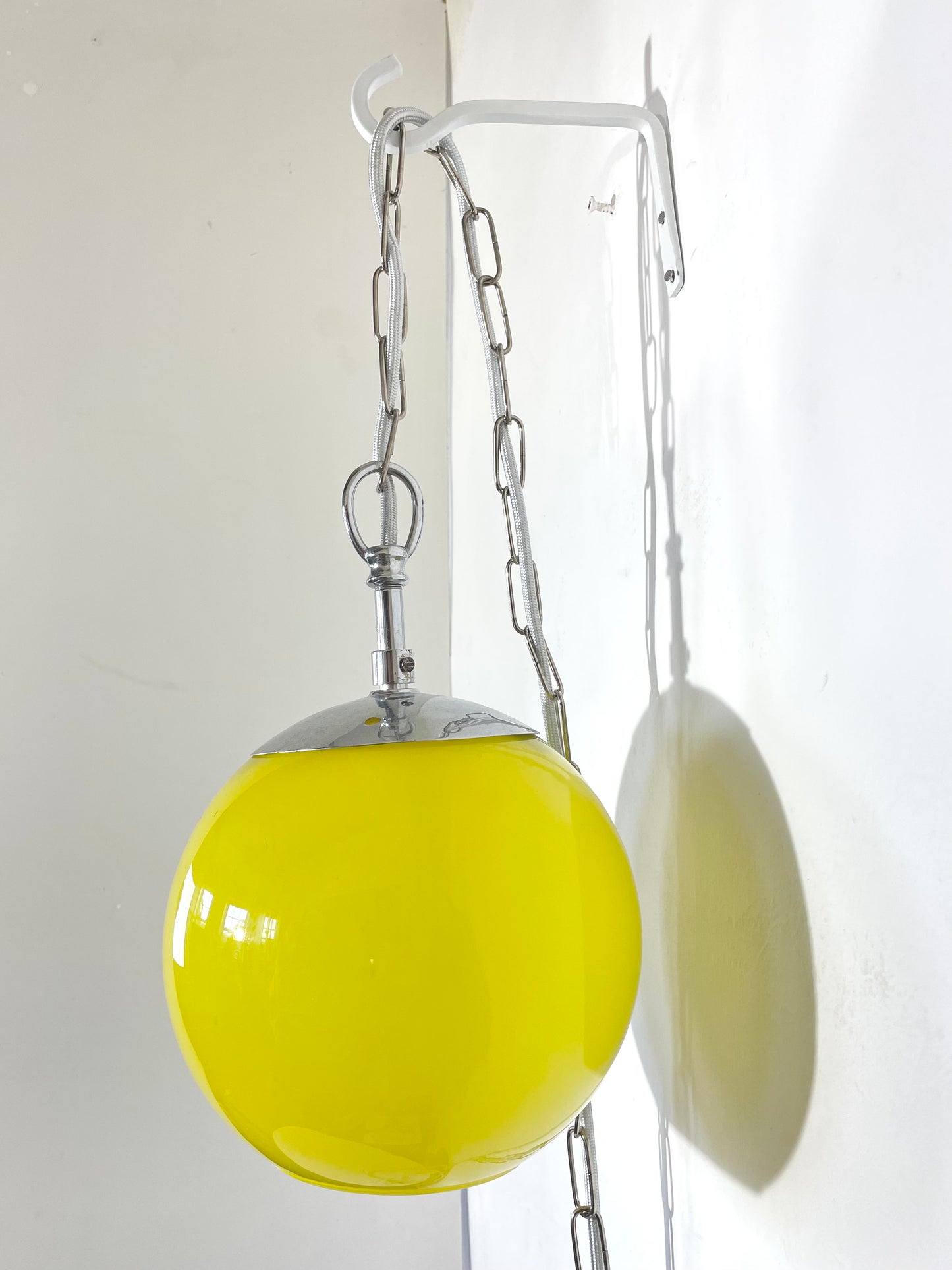 Yellow globe chained pendant lamp