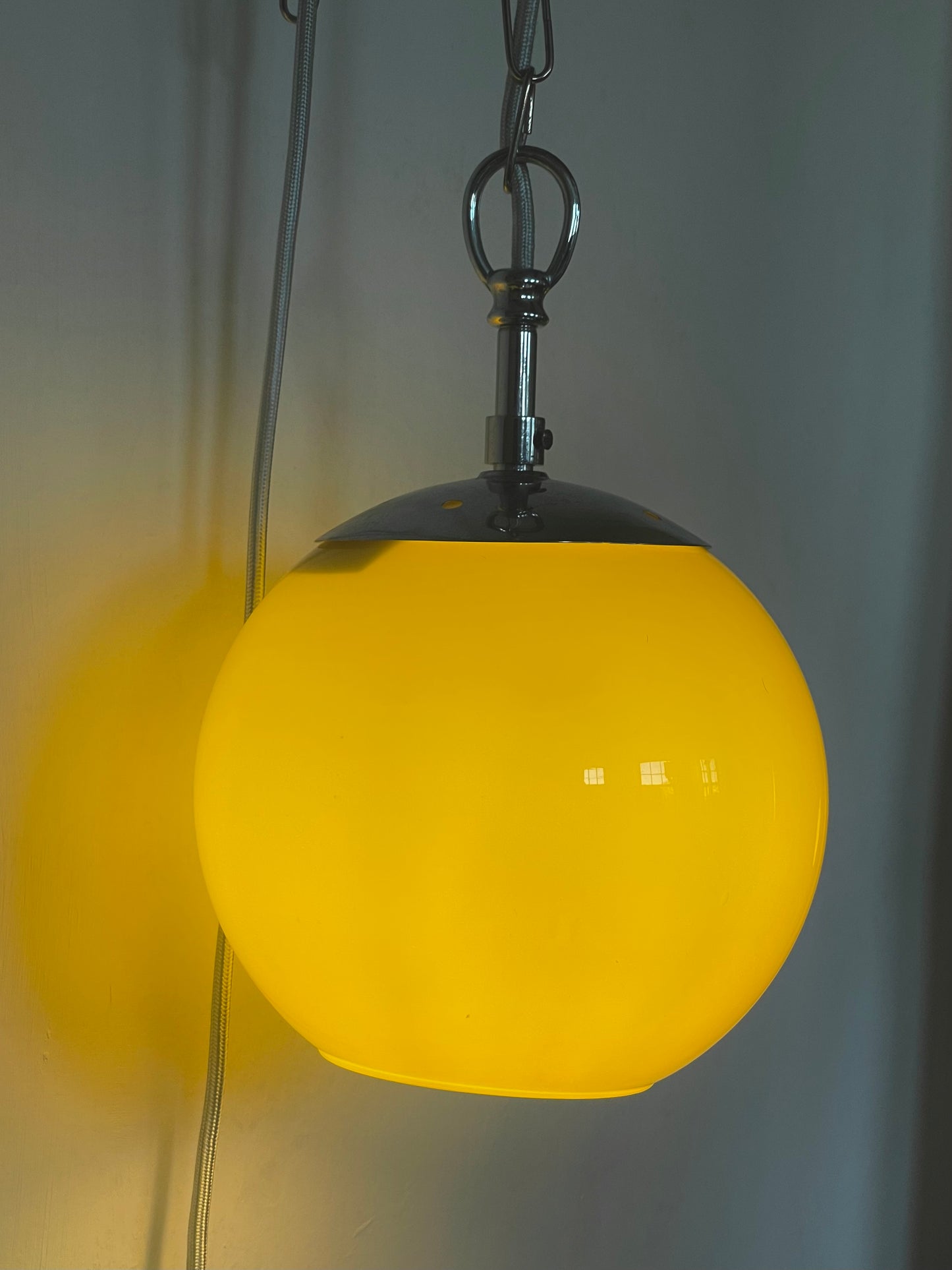 Yellow globe chained pendant lamp
