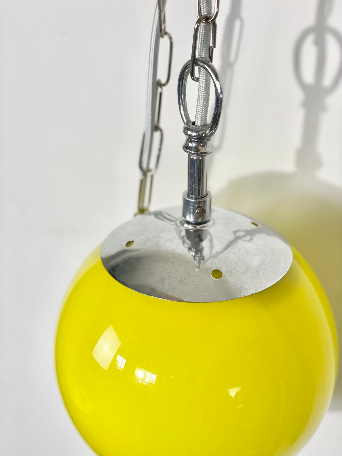 Yellow globe chained pendant lamp