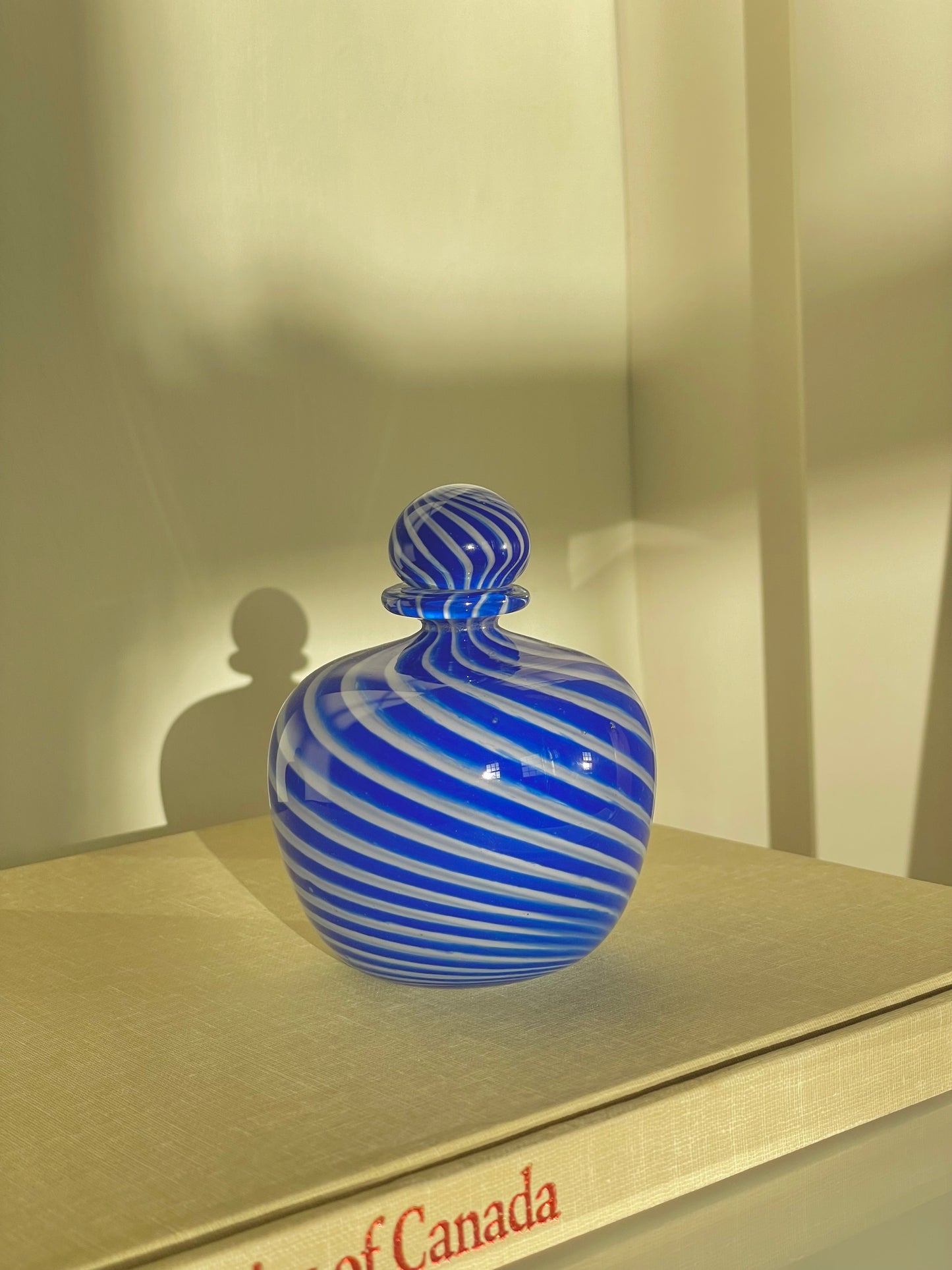 Navy swirl hand blown glass bottle