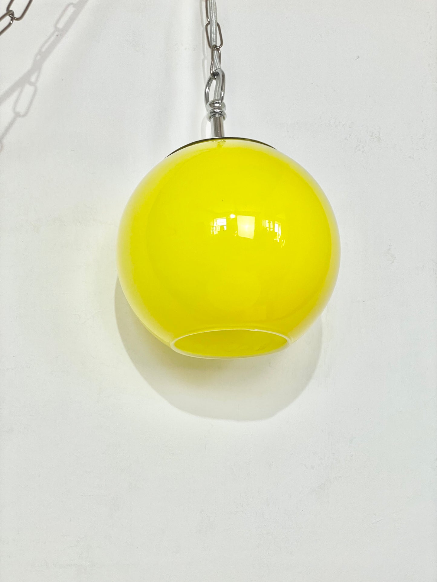 Yellow globe chained pendant lamp