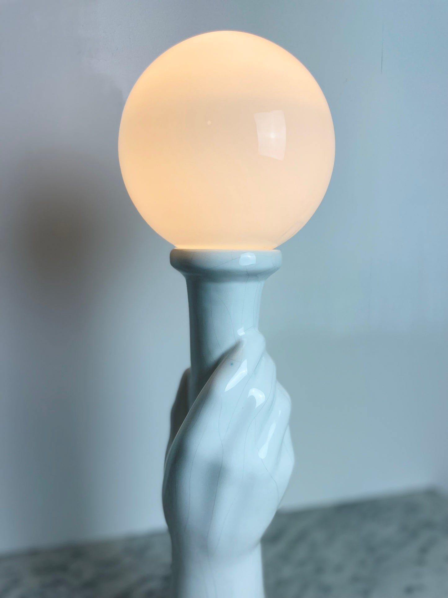 Art Deco style ceramic hand holding torch lamp