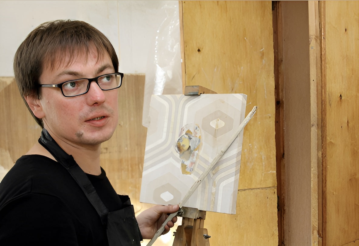 Denis Ichitovkin painting at an easel.