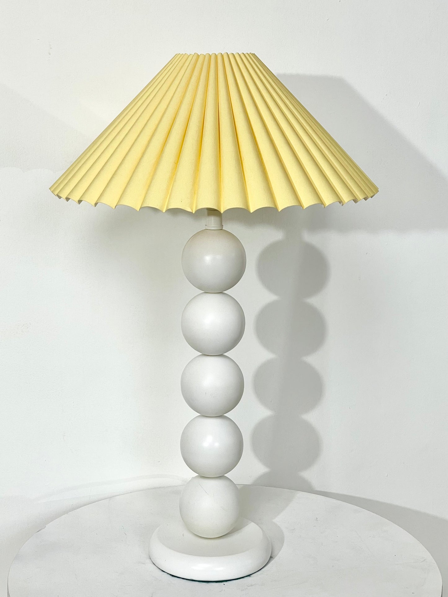 White bobbin lamp with pastel yellow shade