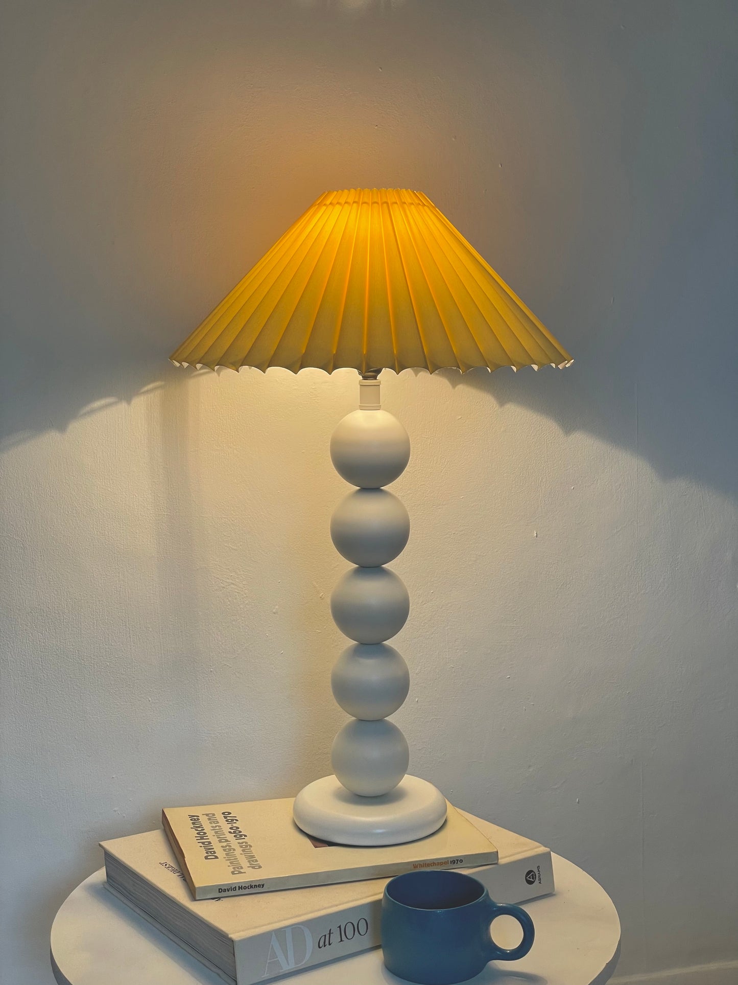 White bobbin lamp with pastel yellow shade